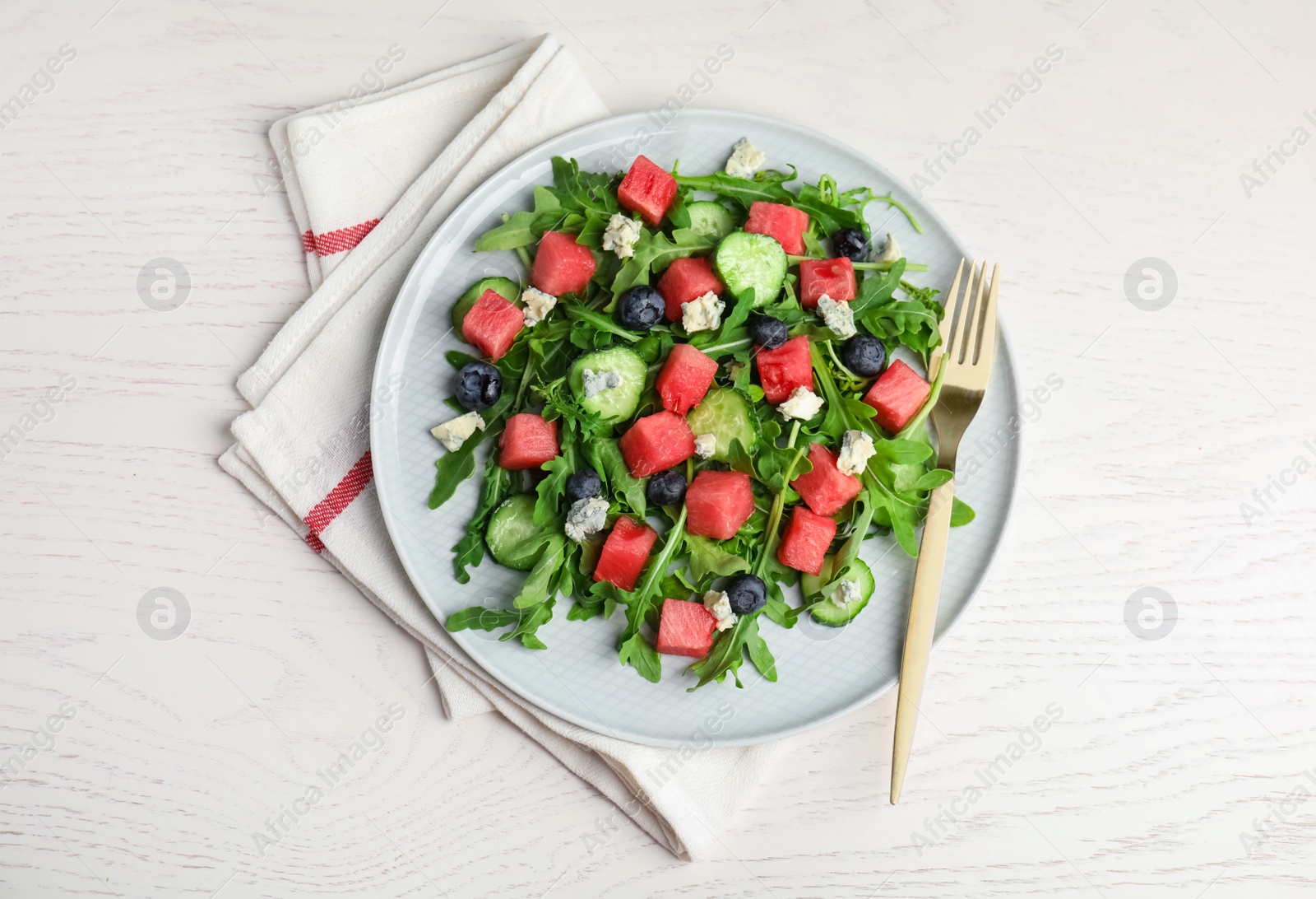 Photo of Delicious salad with watermelon served on white table, flat lay