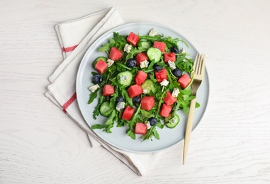 Photo of Delicious salad with watermelon served on white table, flat lay