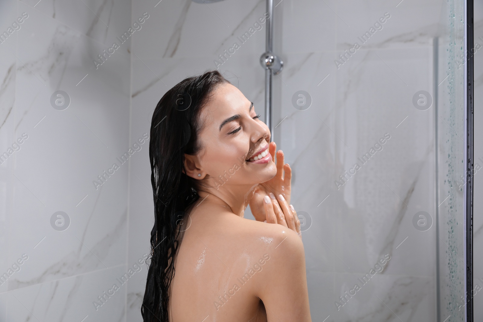 Photo of Beautiful young woman taking shower at home