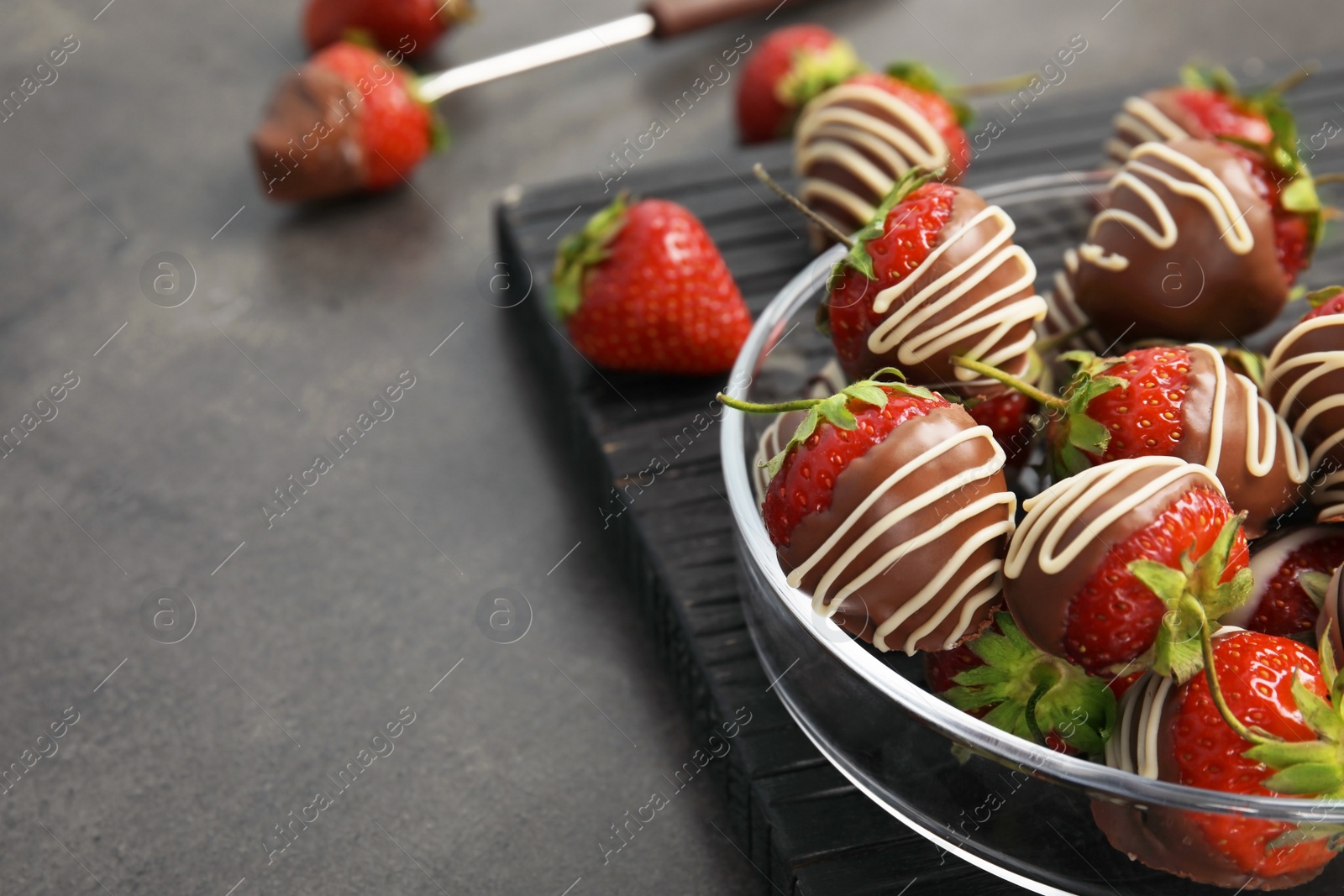 Photo of Plate with chocolate covered strawberries on table, closeup