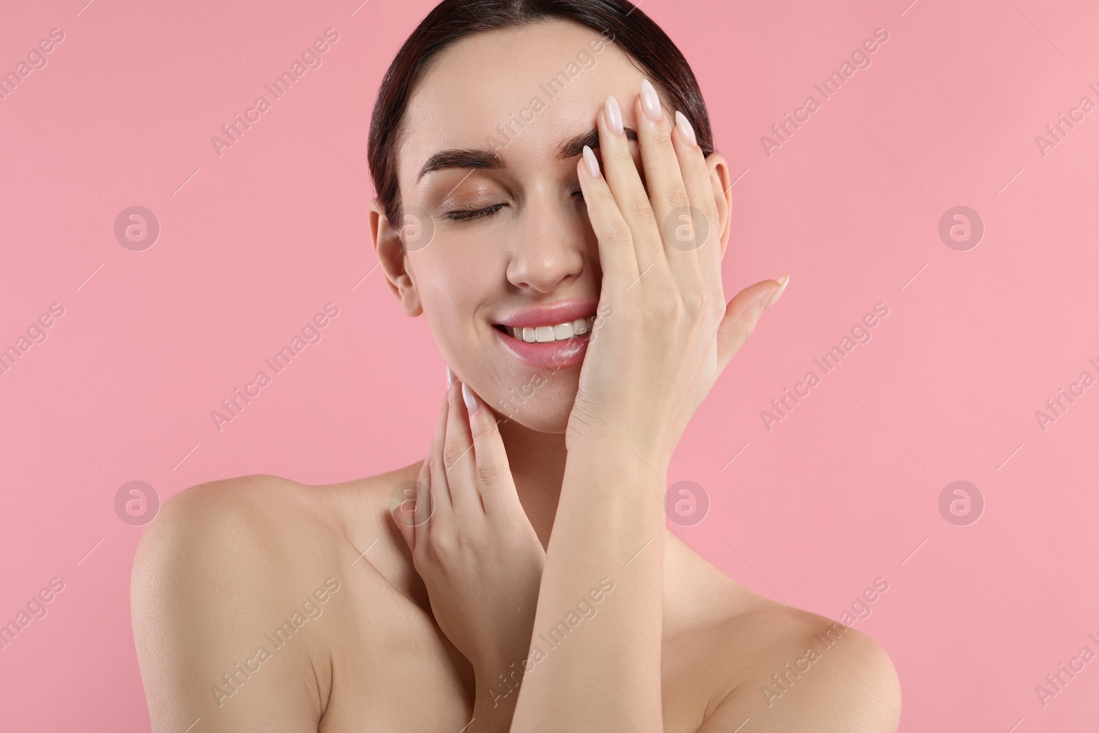 Photo of Portrait of beautiful young woman on pink background