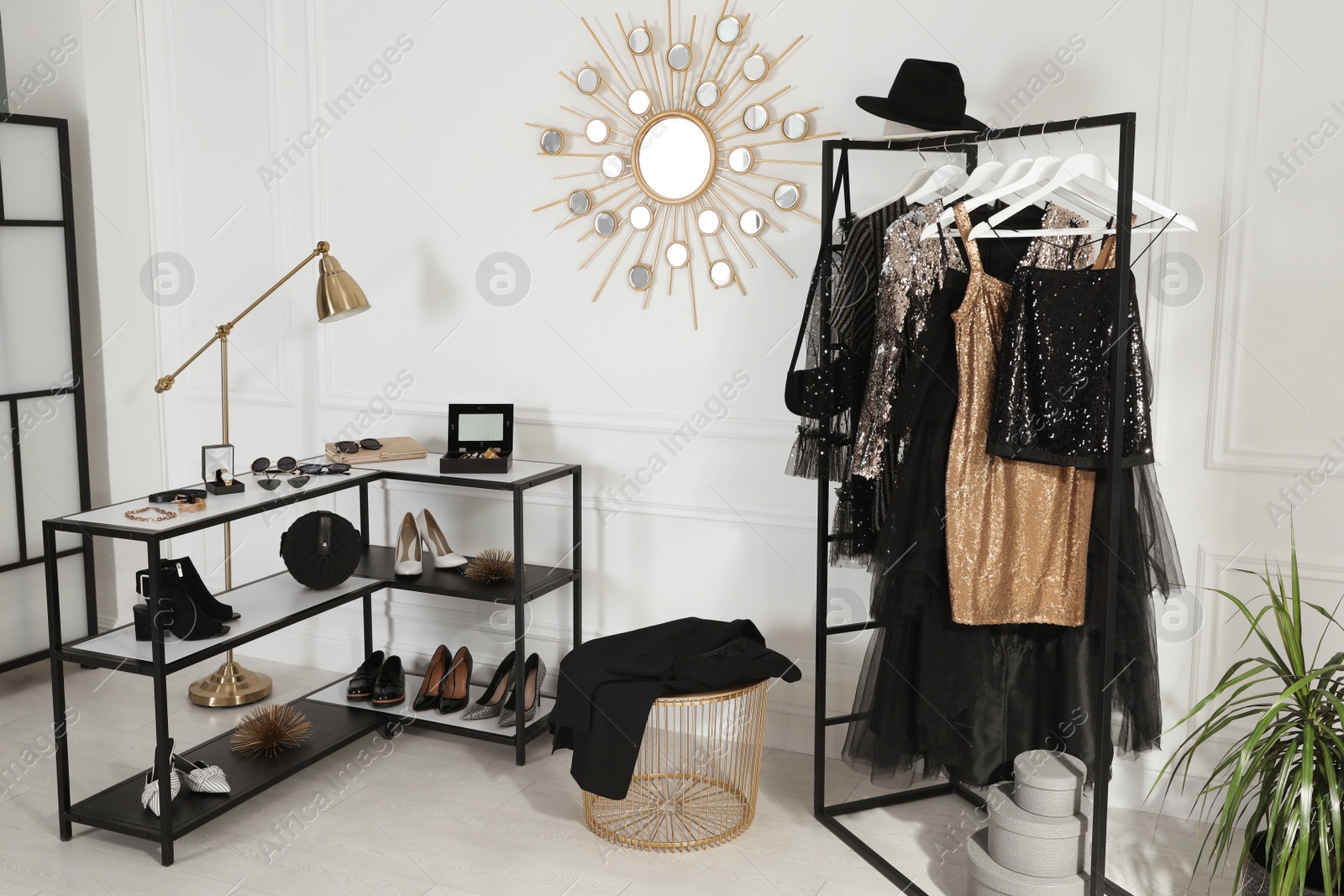 Photo of Stylish dressing room interior with trendy clothes, shoes and accessories