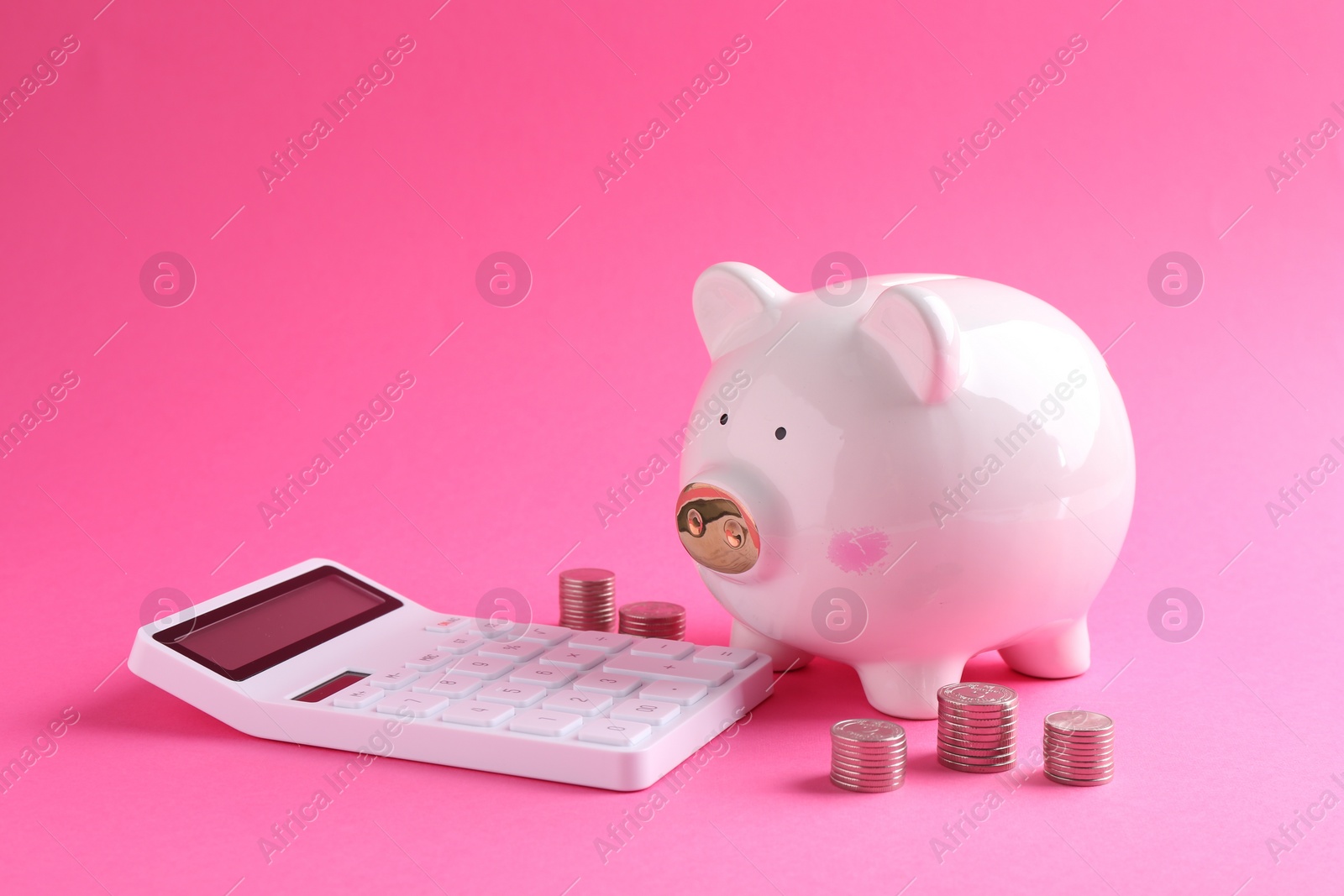 Photo of Financial savings. Piggy bank, coins and calculator on pink background