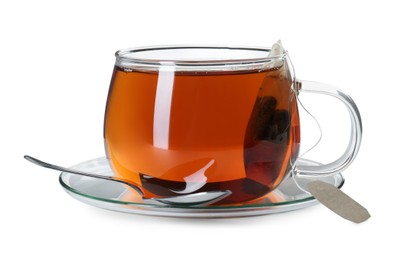 Photo of Brewing aromatic tea. Cup with teabag and spoon isolated on white