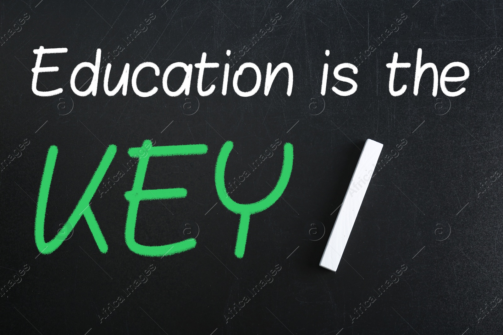 Image of Piece of white chalk and phrase Education is the KEY on blackboard, flat lay. Adult learning
