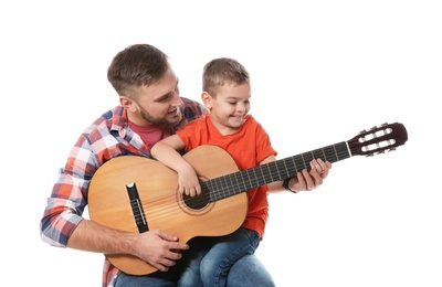 Photo of Father teaching his little son to play guitar on white background