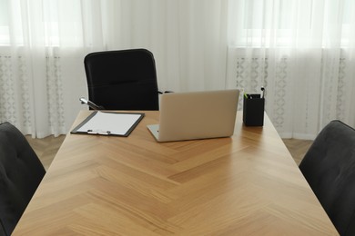 Photo of Director's office with large wooden table and comfortable armchairs. Interior design
