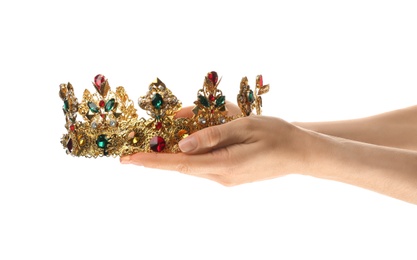 Photo of Woman holding beautiful golden crown on white background, closeup. Fantasy item