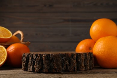 Fresh oranges on wooden table, space for text