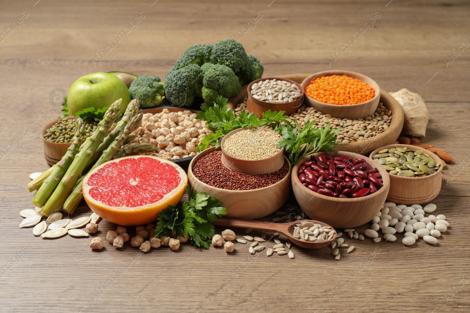 Photo of Fresh vegetables, fruits and seeds on wooden table