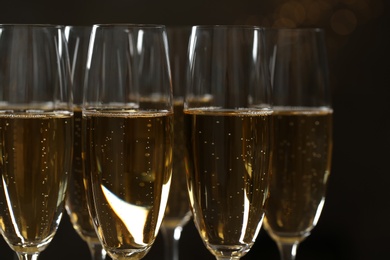 Glasses of champagne on dark background, closeup