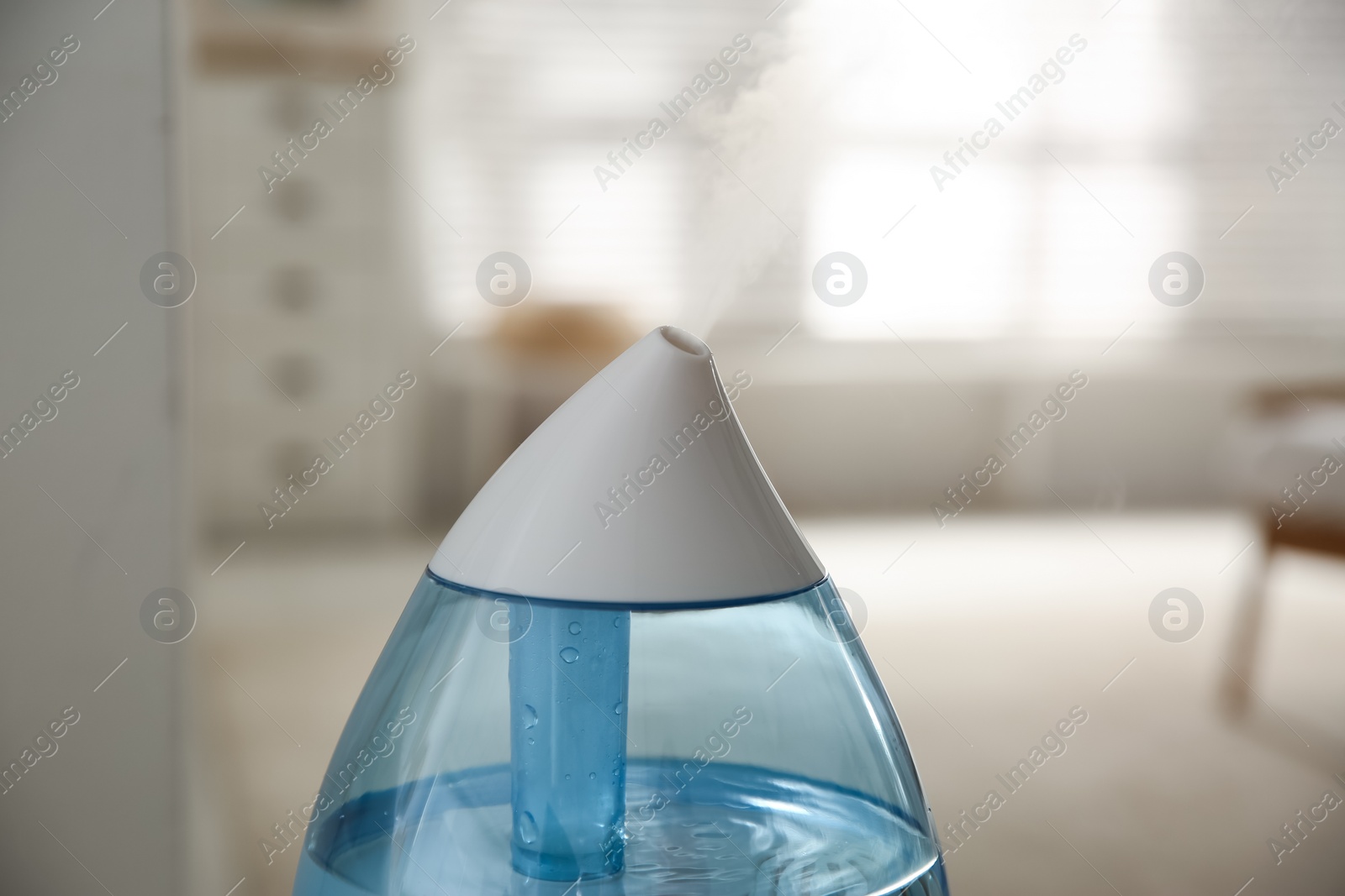 Photo of Modern humidifier indoors, closeup view. Home appliance