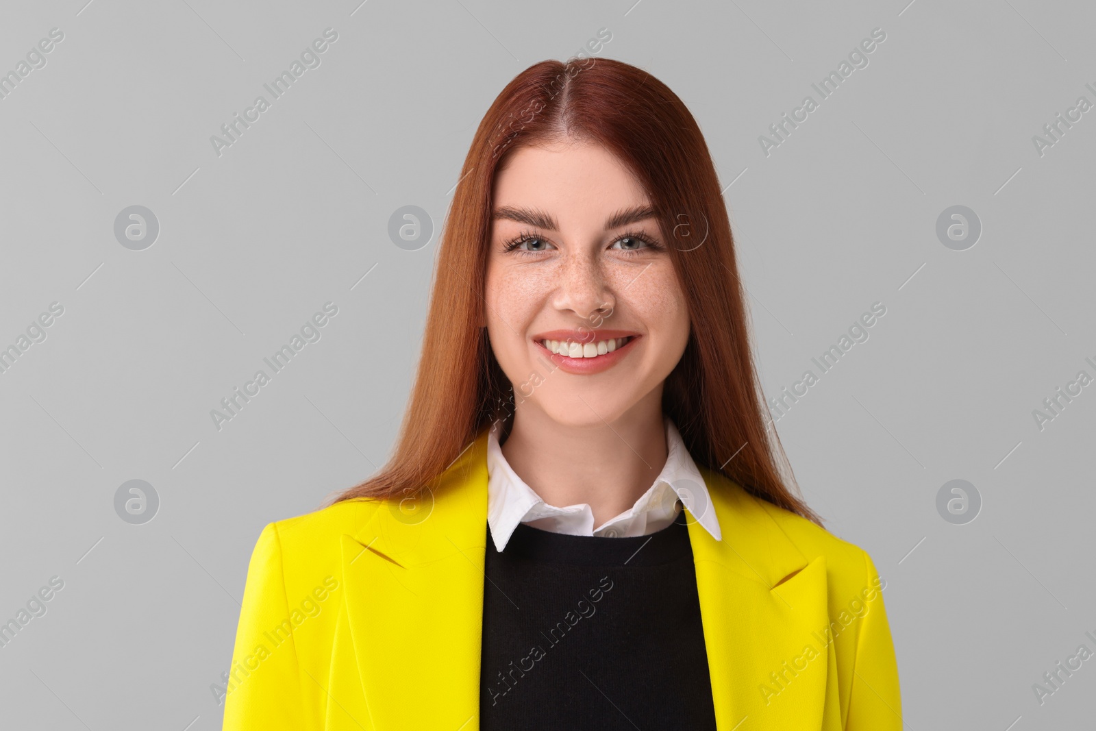 Photo of Portrait of smiling woman on light grey background