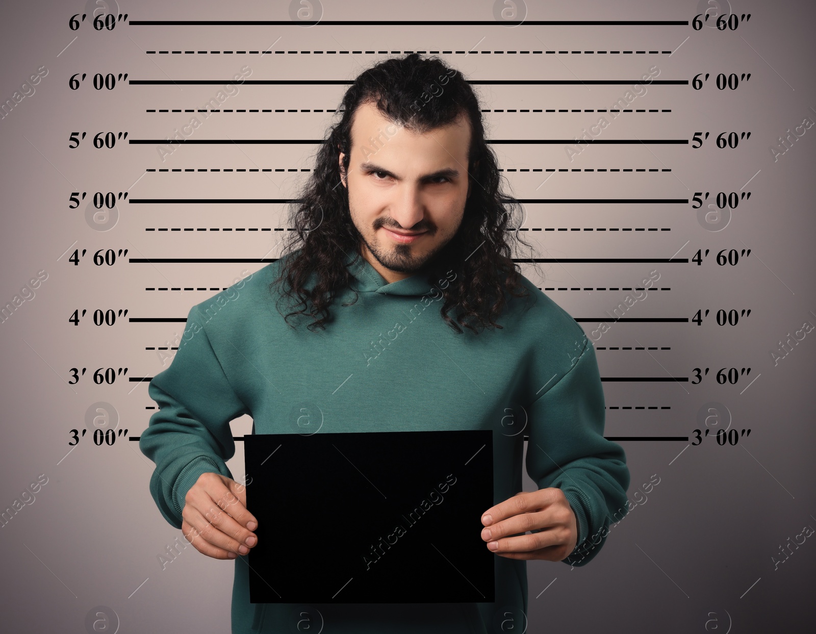 Image of Criminal mugshot. Arrested man with blank card against height chart