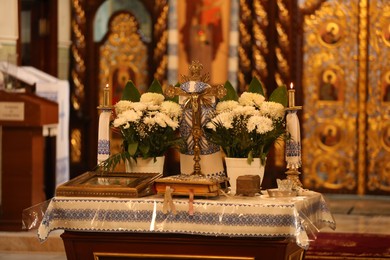 Photo of Stryi, Ukraine - September 11, 2022: Altar with cross, flowers and icon in Assumption of Blessed Virgin Mary cathedral