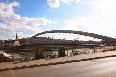 Photo of KRAKOW, POLAND - OCTOBER 18, 2019: Beautiful Father Bernatek Bridge over Vistula river on sunny day