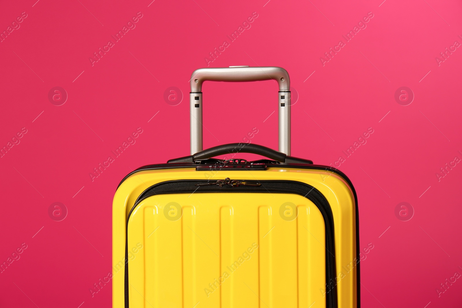 Photo of Stylish carry on suitcase on color background