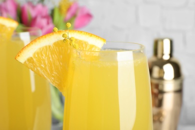 Photo of Glass of Mimosa cocktail with garnish, closeup