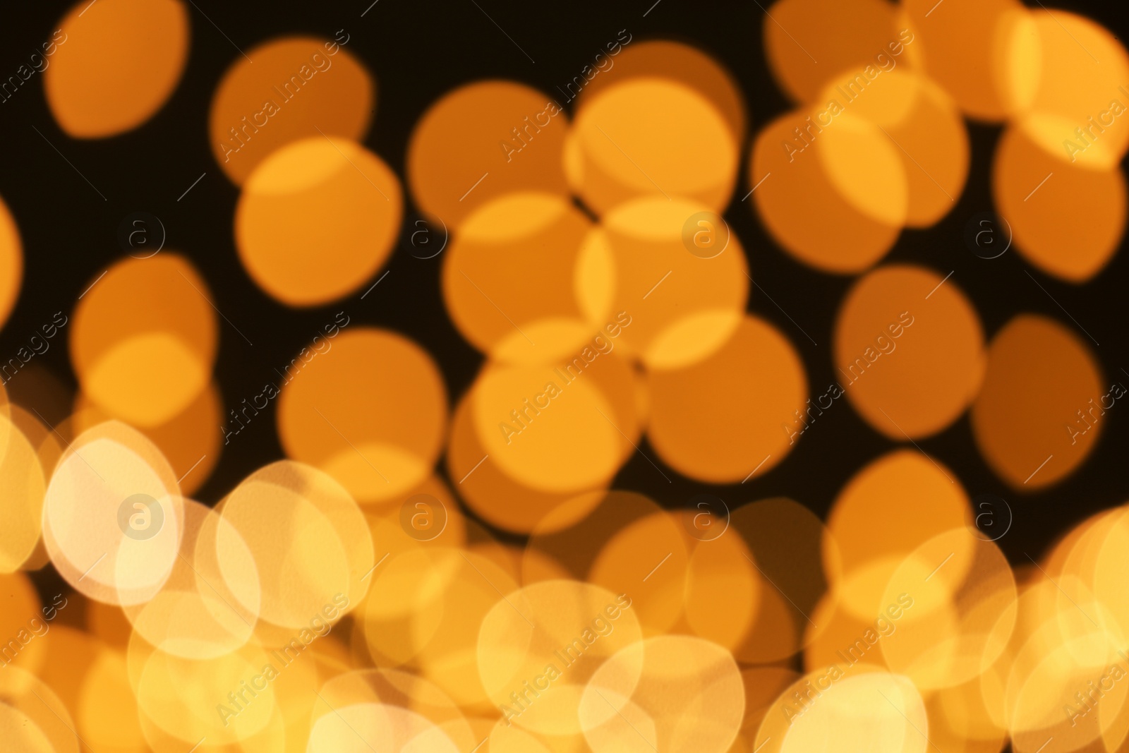 Photo of Beautiful golden lights on dark background. Bokeh effect