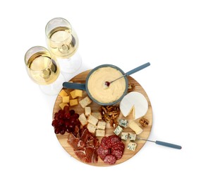 Photo of Fondue with tasty melted cheese, forks, different snacks and wine isolated on white, top view