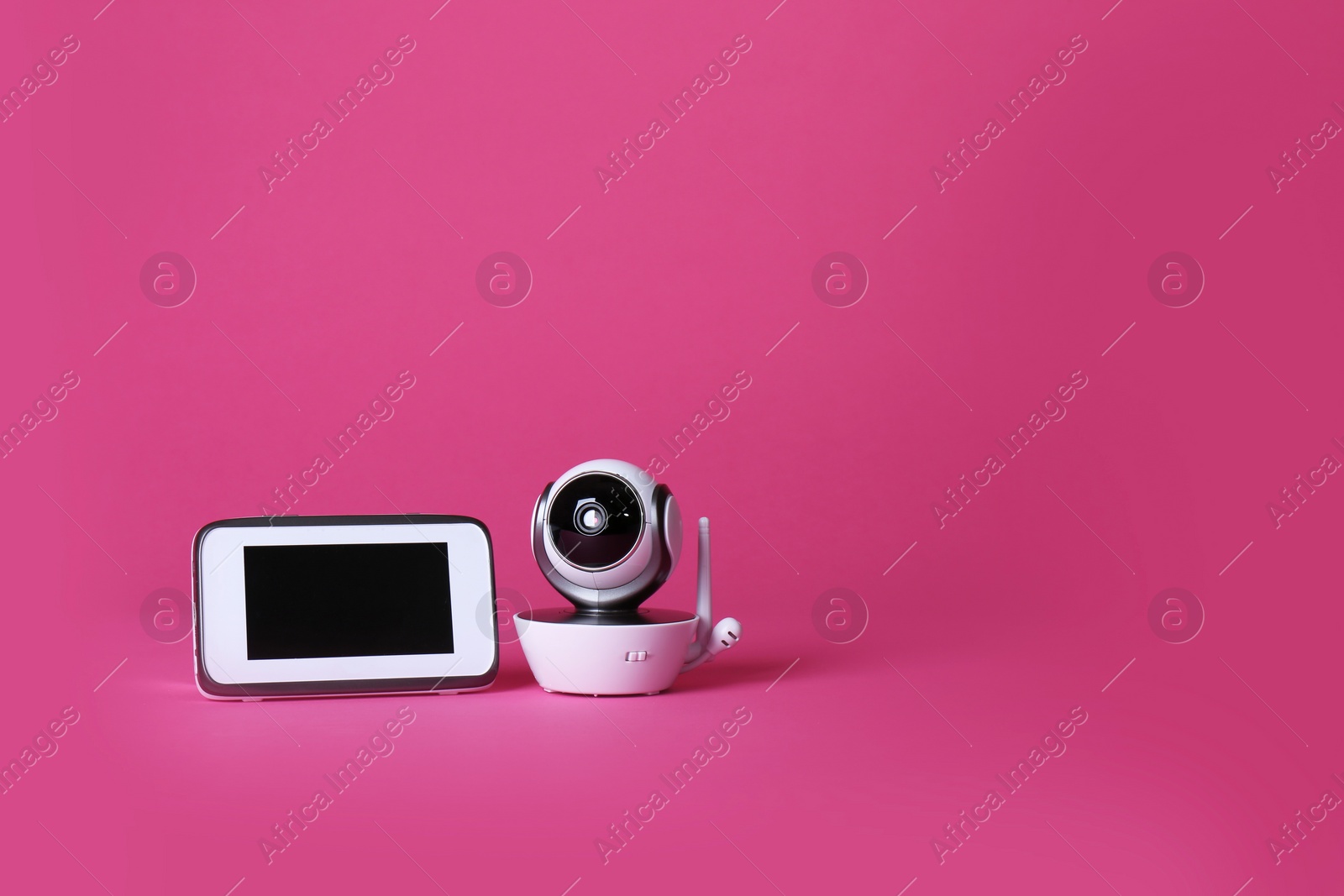 Photo of Modern CCTV security camera and monitor on color background. Space for text