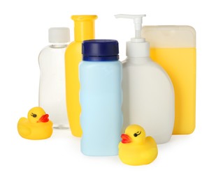 Bottles of baby cosmetic products and rubber ducks on white background