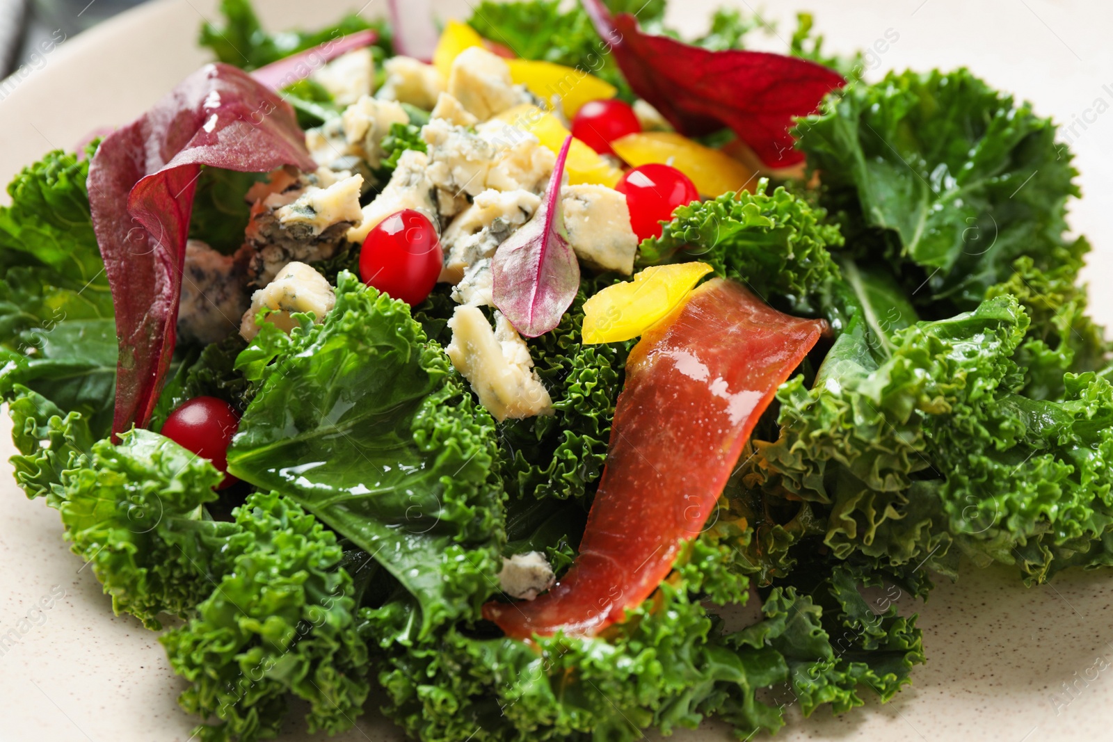 Photo of Plate with tasty fresh kale salad, closeup