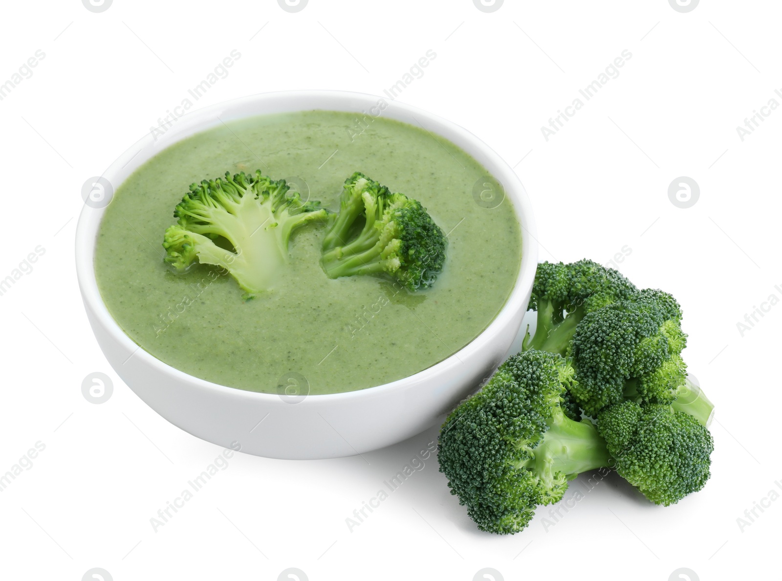 Photo of Delicious broccoli cream soup in bowl isolated on white