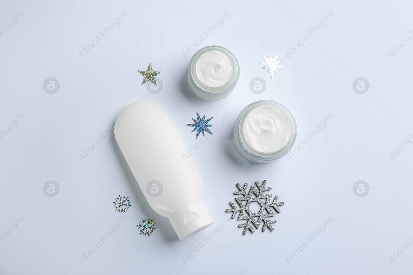 Photo of Set of different cosmetic products on white background, flat lay. Winter care