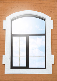 Photo of Brick building with beautiful modern arch window