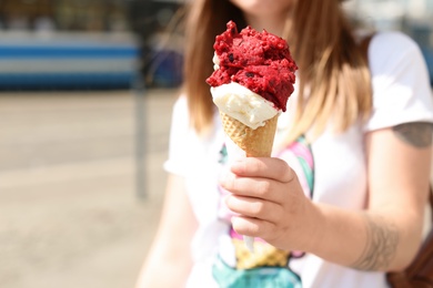 Photo of Young woman with delicious ice cream outdoors