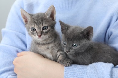 Photo of Woman with cute fluffy kittens, closeup view