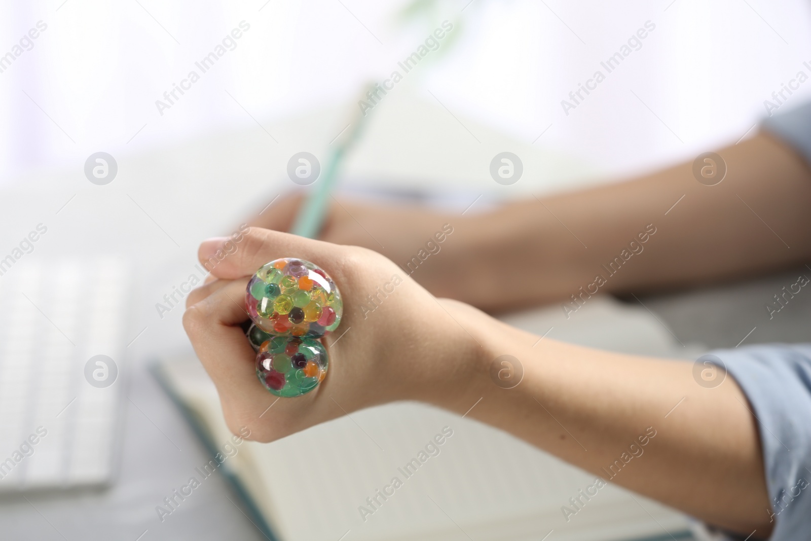 Photo of Woman squeezing colorful slime, closeup. Antistress toy