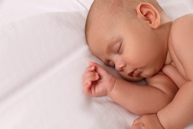 Photo of Cute little baby sleeping on bed, above view. Space for text