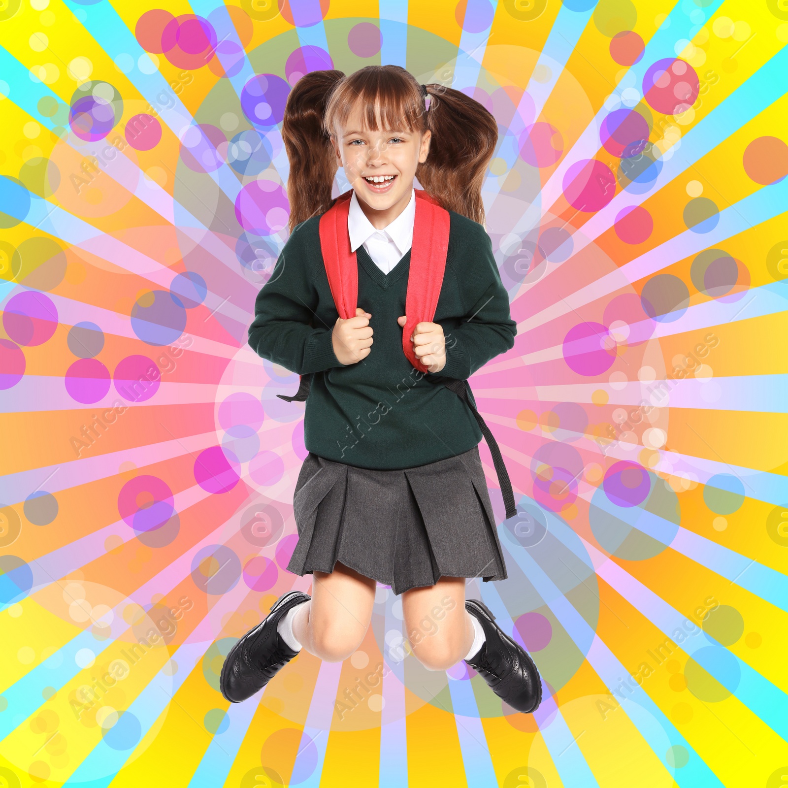 Image of Little girl jumping on colorful background. School holidays