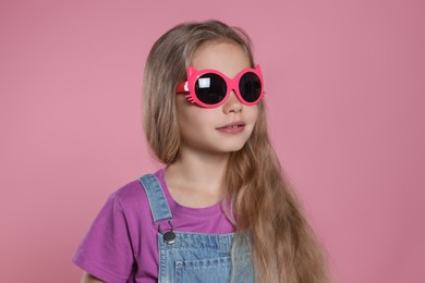 Photo of Girl in stylish sunglasses on pink background