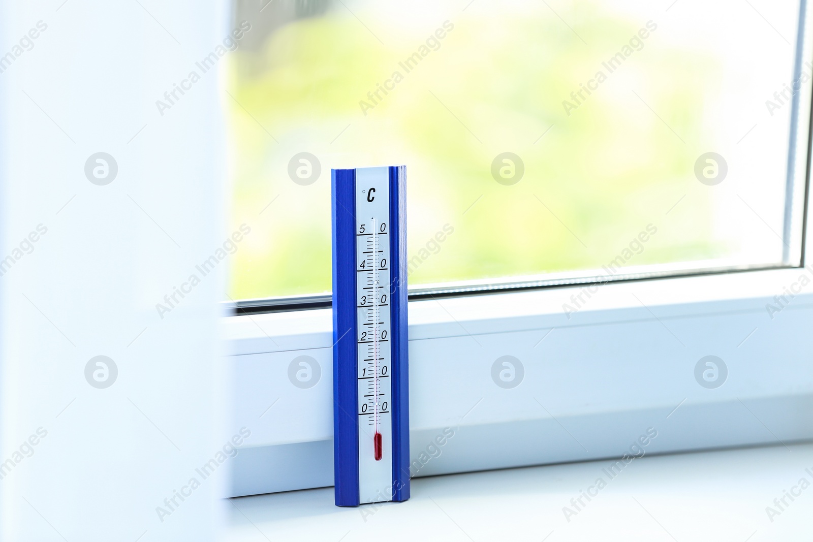 Photo of Weather thermometer on window sill indoors. Space for text