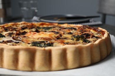 Photo of Delicious quiche with mushrooms on white table, closeup
