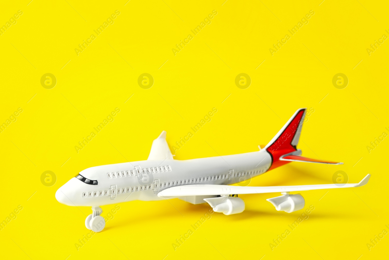 Photo of Toy plane  on yellow background, space for text. Logistics and wholesale concept