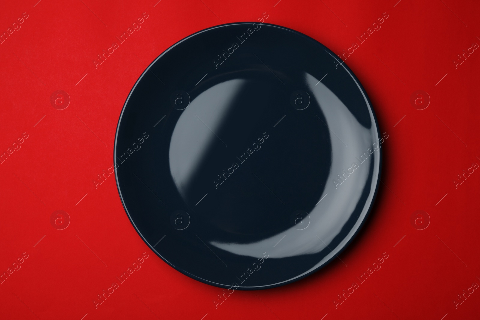 Photo of Clean empty plate on color background, top view