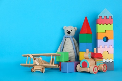 Photo of Set of different toys on blue background. Space for text