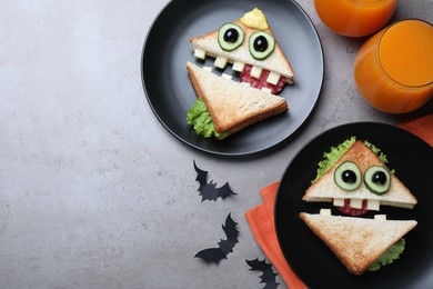Photo of Cute monster sandwiches served on grey table, flat lay with space for text. Halloween party food