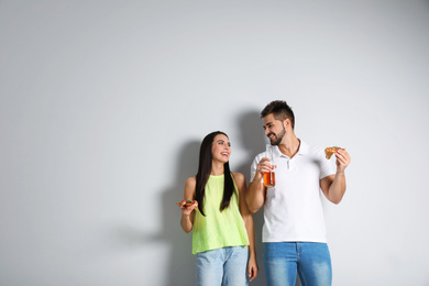 Photo of Happy couple with pizza and beer on white background, copy space text
