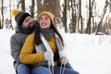 Portrait of happy young couple outdoors on winter day