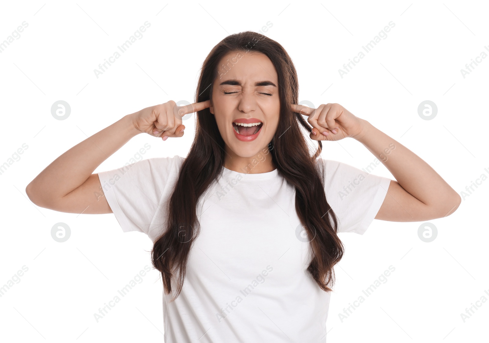 Photo of Emotional young woman covering ears with fingers on white background