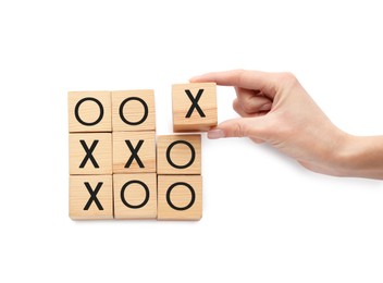 Photo of Woman playing tic tac toe game on white background, top view