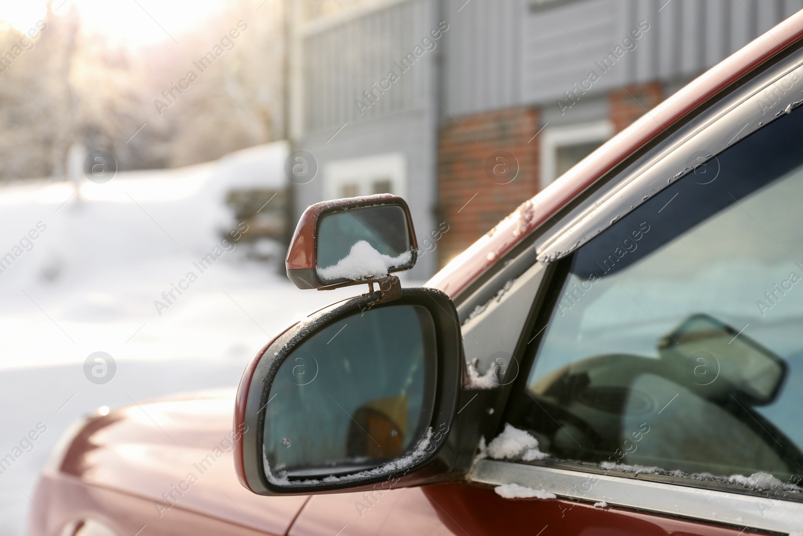 Photo of Side view mirror of car on snowy winter day, closeup