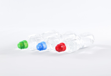 Photo of Plastic bottles with pure water on white background