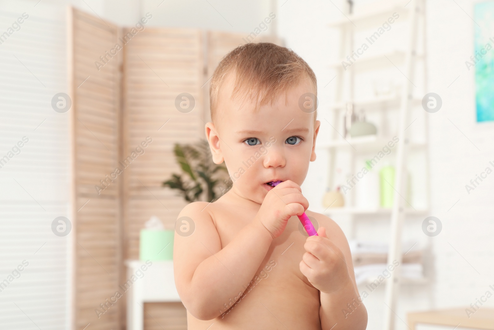 Photo of Cute little boy with toothbrush on blurred background