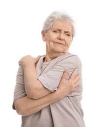 Elderly woman suffering from pain in shoulder on white background